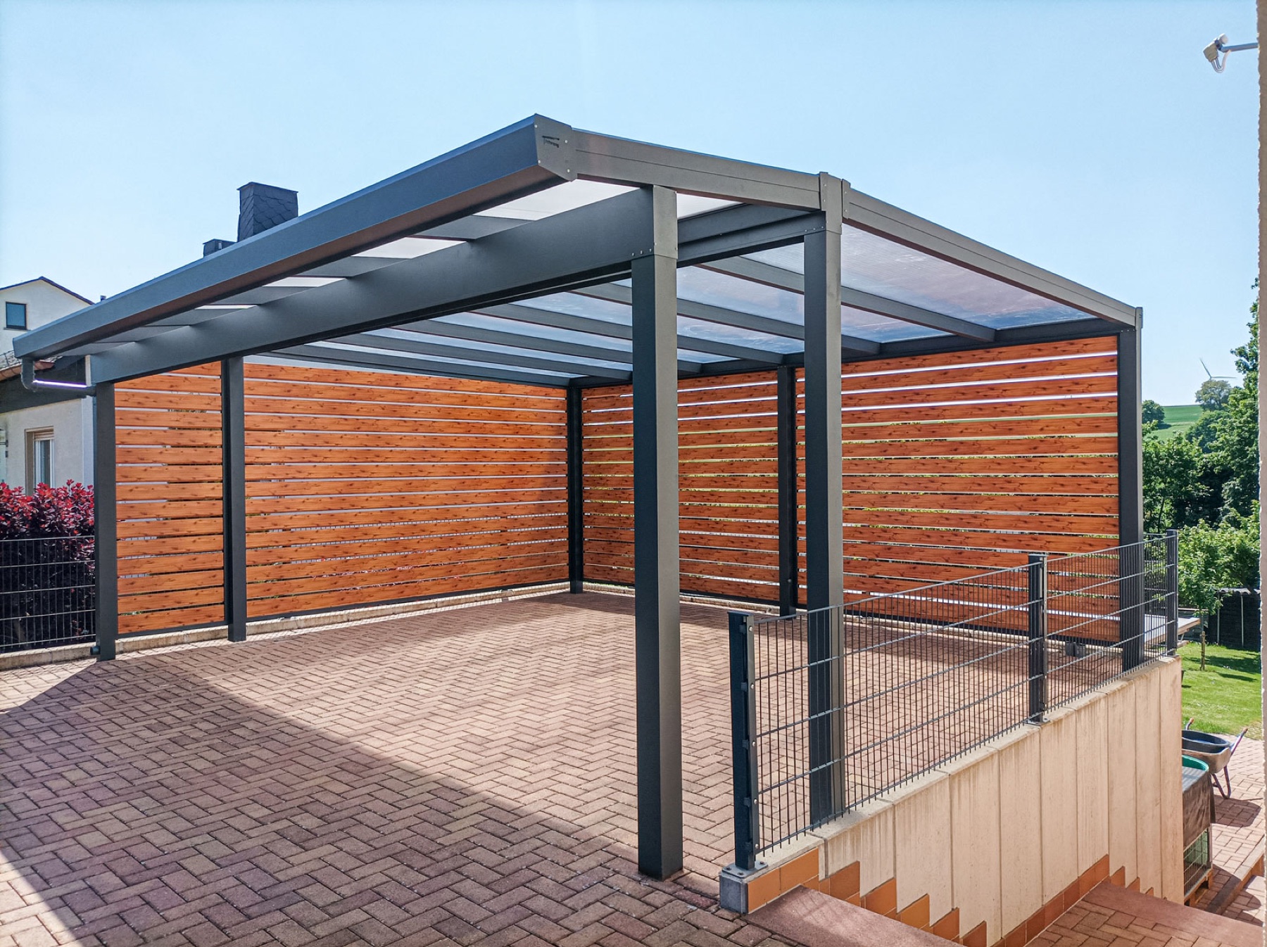 Carport mit lichtdurchlässiger Dacheindeckung und Holzoptik-Seitenwänden